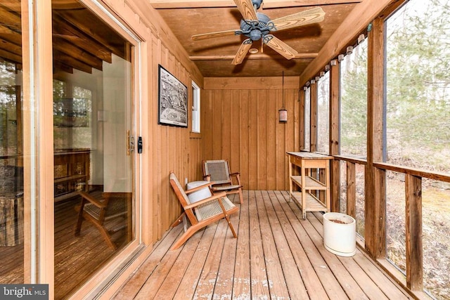 sunroom featuring ceiling fan and wooden ceiling