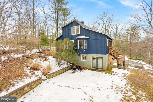 view of snow covered back of property