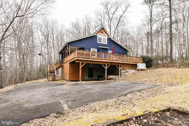 rear view of property featuring a deck