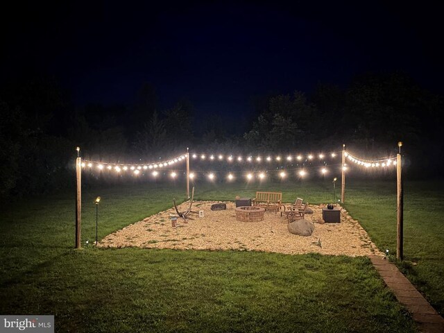 yard at twilight featuring a fire pit