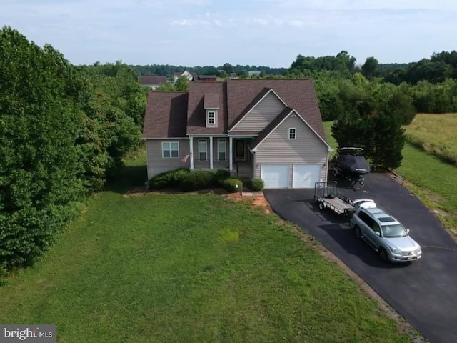 view of front of property featuring a garage and a front yard