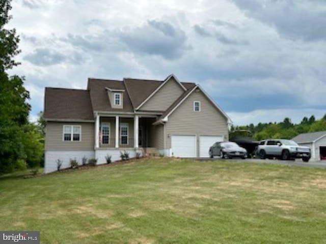 view of front of home with a garage and a front lawn