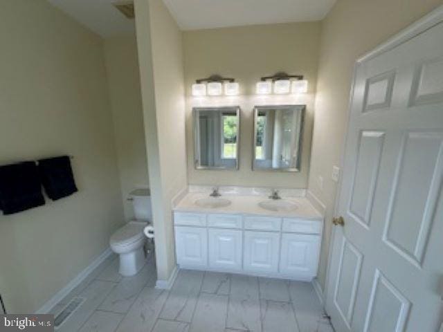 bathroom featuring vanity and toilet