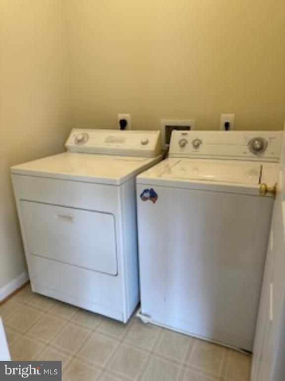 clothes washing area featuring washer and clothes dryer