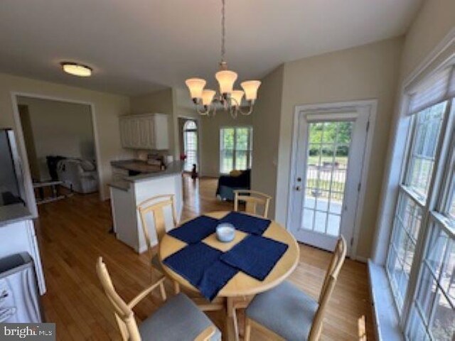 dining room featuring dark hardwood / wood-style floors and a chandelier