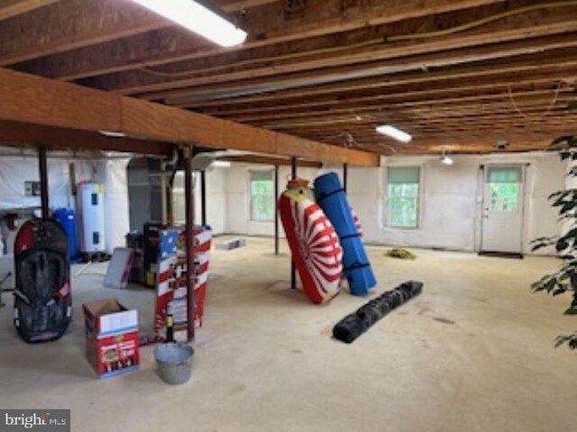 basement with water heater and plenty of natural light