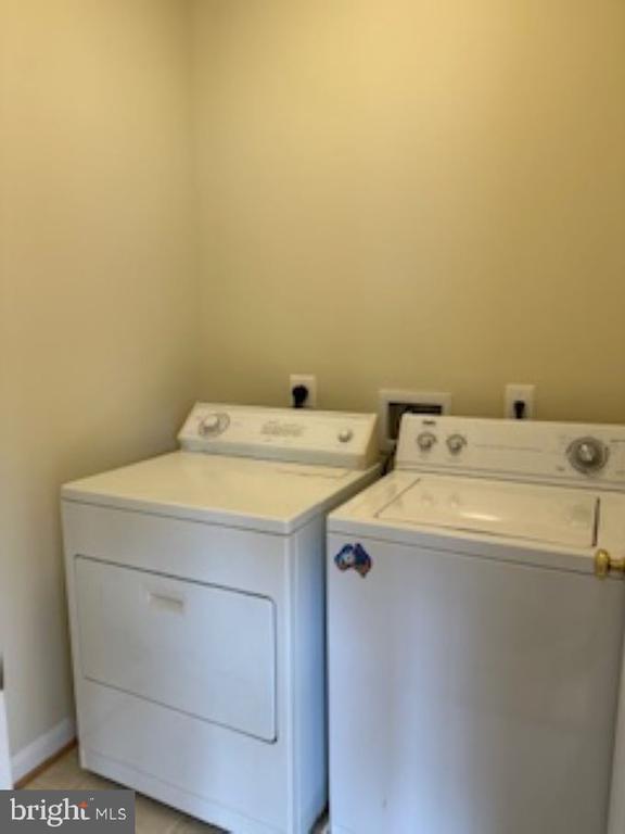 clothes washing area with washing machine and clothes dryer