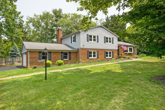 2822 Plantation Ln, Waynesboro, VA 22980 - tri-level home featuring brick siding, a chimney, asphalt driveway, and an attached garage