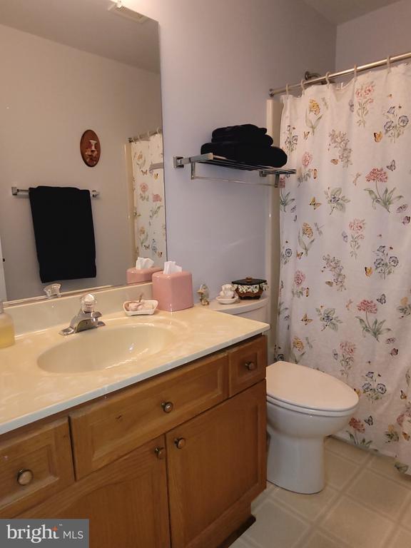 11611 Hampshire Ct, Fredericksburg, VA 22407 - full bath with vanity, toilet, tile patterned floors, and a shower with curtain