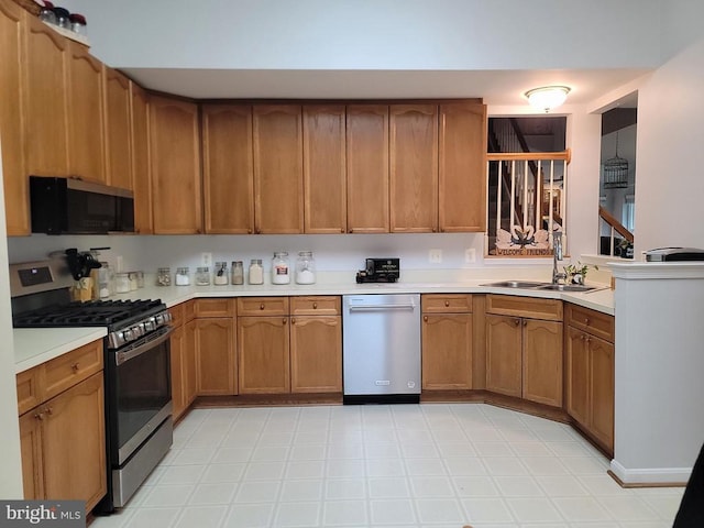 11611 Hampshire Ct, Fredericksburg, VA 22407 - kitchen featuring appliances with stainless steel finishes, a sink, light countertops, brown cabinets, and light flooring