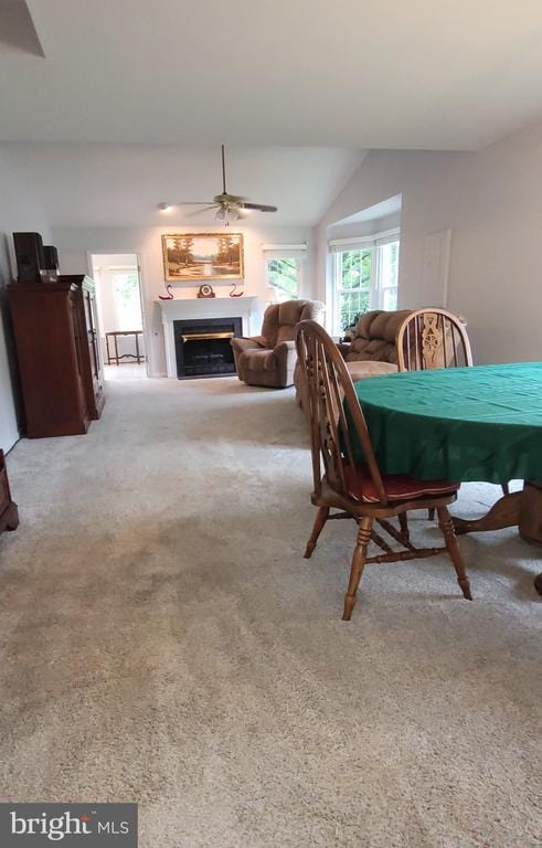 11611 Hampshire Ct, Fredericksburg, VA 22407 - dining space featuring ceiling fan, a glass covered fireplace, carpet flooring, and vaulted ceiling