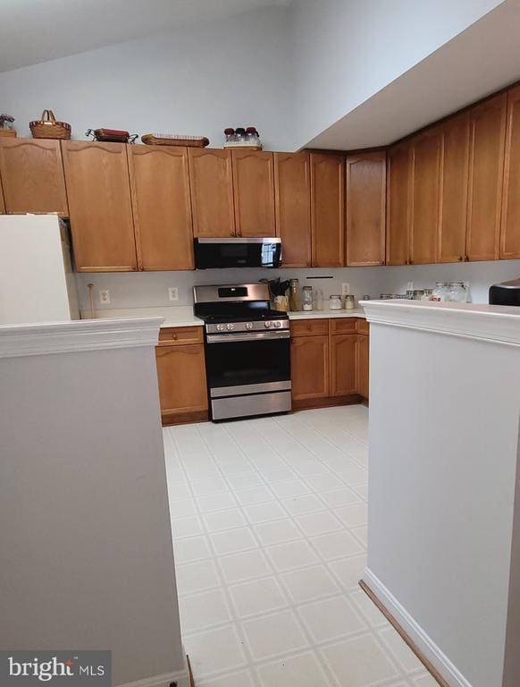 11611 Hampshire Ct, Fredericksburg, VA 22407 - kitchen with appliances with stainless steel finishes, light countertops, and brown cabinetry