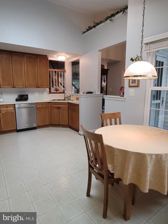 11611 Hampshire Ct, Fredericksburg, VA 22407 - kitchen with dishwasher, brown cabinetry, high vaulted ceiling, light countertops, and a sink
