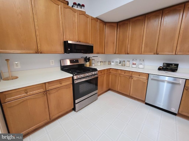11611 Hampshire Ct, Fredericksburg, VA 22407 - kitchen featuring stainless steel appliances, light countertops, and brown cabinetry