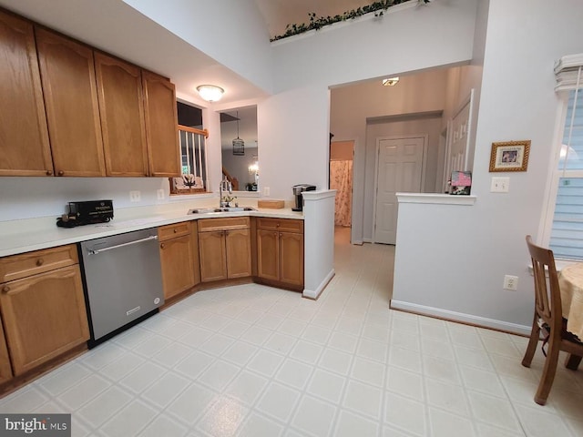 11611 Hampshire Ct, Fredericksburg, VA 22407 - kitchen with dishwasher, a sink, light countertops, brown cabinets, and a towering ceiling