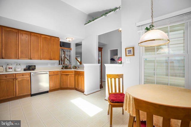 11611 Hampshire Ct, Fredericksburg, VA 22407 - kitchen featuring dishwasher, a towering ceiling, brown cabinets, light countertops, and light flooring