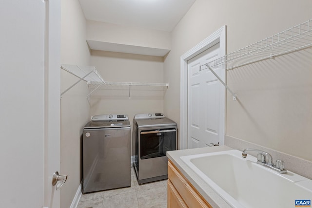 75 Cottage Ct, Zion Crossroads, VA 22942 - laundry area with washer and clothes dryer and light tile patterned floors