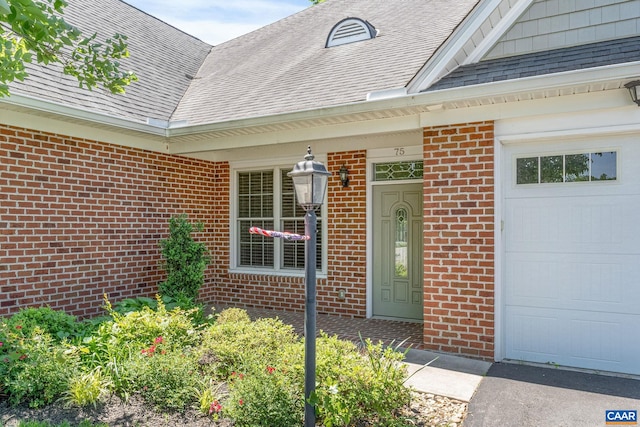 75 Cottage Ct, Zion Crossroads, VA 22942 - view of exterior entry featuring brick siding, roof with shingles, and a garage