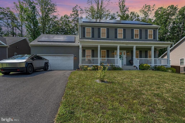 8806 Commons Cir, Spotsylvania, VA 22553 - colonial inspired home featuring a porch, solar panels, an attached garage, and driveway