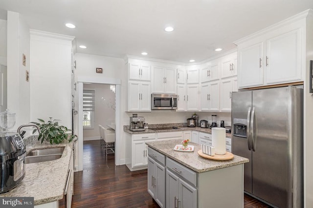 8806 Commons Cir, Spotsylvania, VA 22553 - kitchen with appliances with stainless steel finishes, dark wood-type flooring, white cabinetry, recessed lighting, and light stone countertops