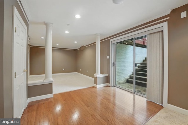 538 Colony Ct, Warrenton, VA 20186 - empty room with decorative columns, ornamental molding, wood finished floors, baseboards, and stairway