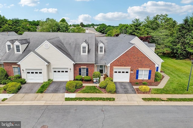 view of front facade featuring brick siding, asphalt driveway, and a front lawn
