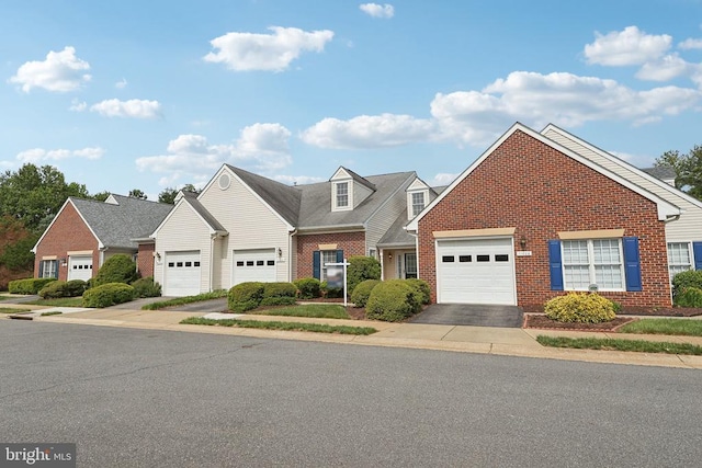 traditional-style house with brick siding, asphalt driveway, and a garage