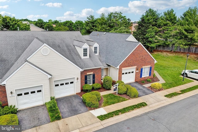 view of front of home with brick siding, asphalt driveway, a garage, and roof with shingles