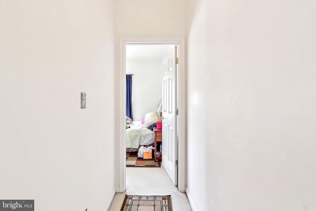 hallway featuring light carpet