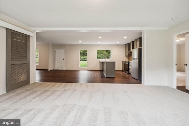 8708 Berkeley Farms Ln, Partlow, VA 22534 - unfurnished living room with a sink, dark colored carpet, dark wood-type flooring, and recessed lighting