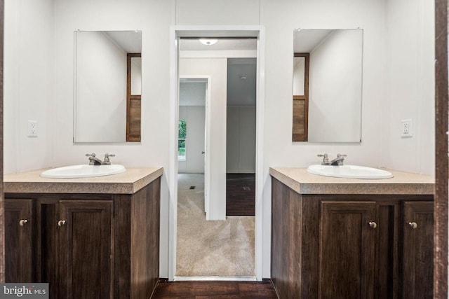 8708 Berkeley Farms Ln, Partlow, VA 22534 - bathroom with two vanities, a sink, and wood finished floors
