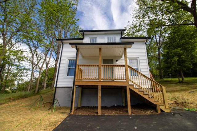 view of front of property featuring stairs and a wooden deck