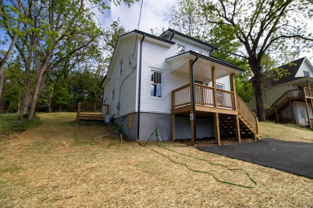 back of house with stairway and a deck
