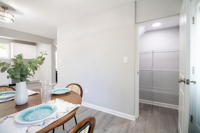 dining room with light wood-type flooring and baseboards