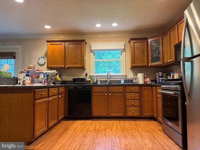 11068 Alum Springs Rd, Culpeper, VA 22701 - kitchen with black appliances, brown cabinetry, ornamental molding, light wood-style floors, and a peninsula