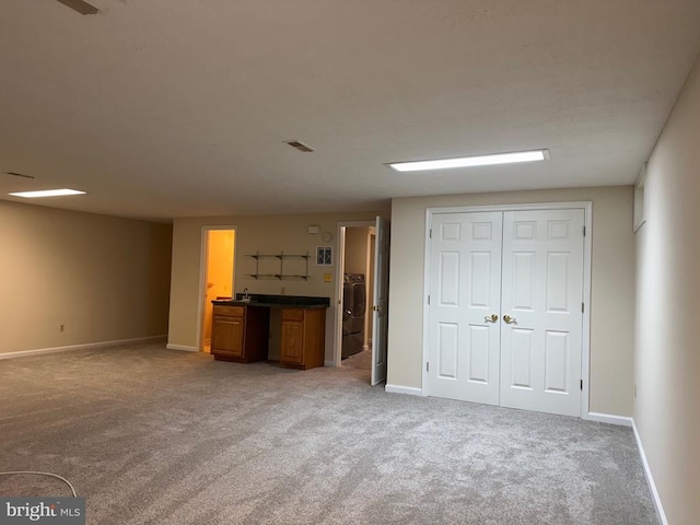 11068 Alum Springs Rd, Culpeper, VA 22701 - unfurnished living room featuring light colored carpet, washer / dryer, and bar
