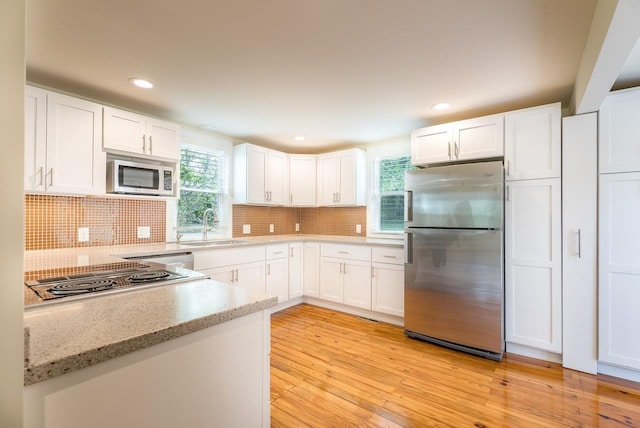 2860 Uphill Dr, Broadway, VA 22815 - kitchen featuring freestanding refrigerator, cooktop, a sink, white cabinetry, and light wood-type flooring