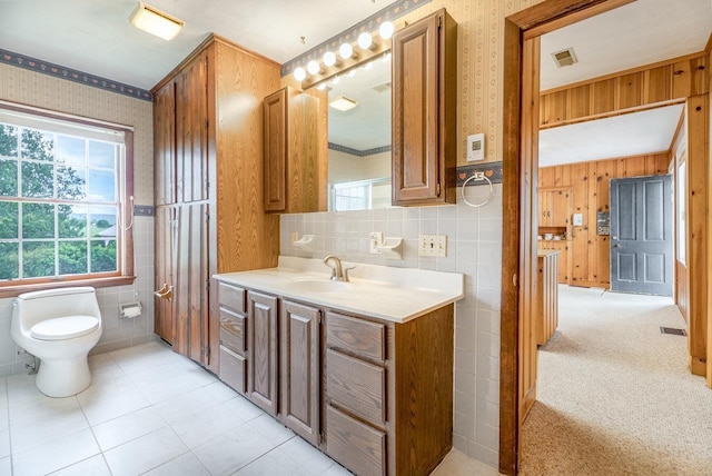 2860 Uphill Dr, Broadway, VA 22815 - bathroom featuring tile walls, toilet, vanity, wallpapered walls, and tile patterned flooring