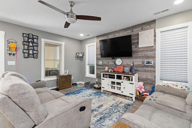 120 Gay St W, Staunton, VA 24401 - living area with wood finished floors, ceiling fan, an accent wall, recessed lighting, and baseboards