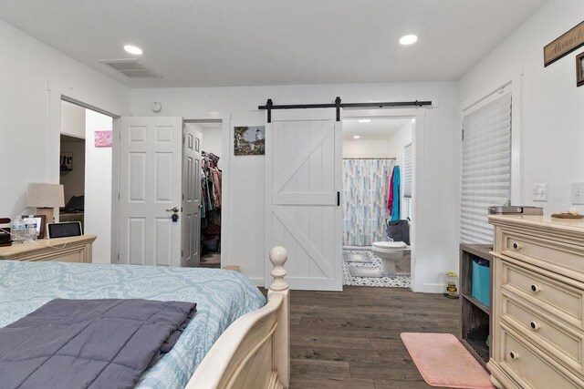 120 Gay St W, Staunton, VA 24401 - bedroom with dark wood-style floors, a spacious closet, a barn door, recessed lighting, and ensuite bathroom