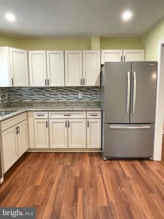 4504 Mine Rd, Fredericksburg, VA 22408 - kitchen with freestanding refrigerator, backsplash, a sink, wood finished floors, and light stone counters