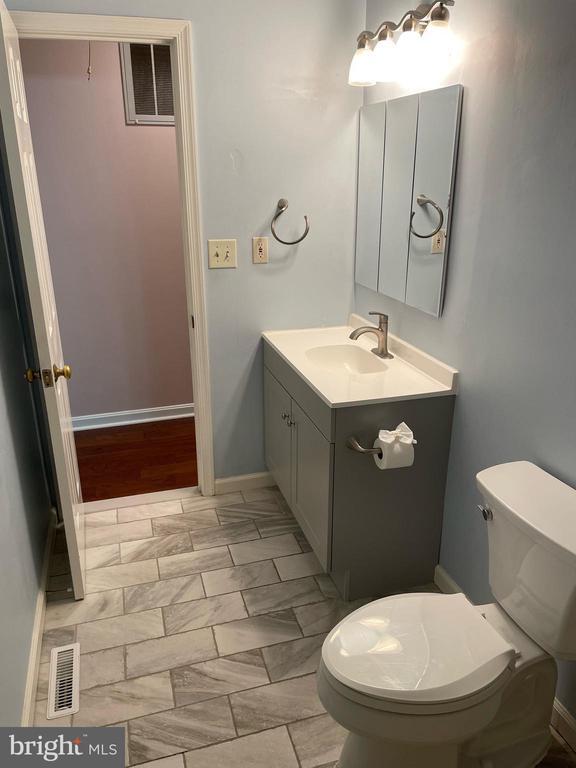 4504 Mine Rd, Fredericksburg, VA 22408 - half bath featuring toilet, vanity, and baseboards