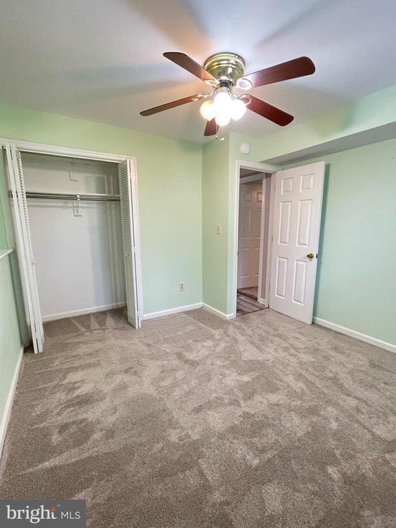4504 Mine Rd, Fredericksburg, VA 22408 - unfurnished bedroom featuring carpet flooring, a closet, baseboards, and ceiling fan