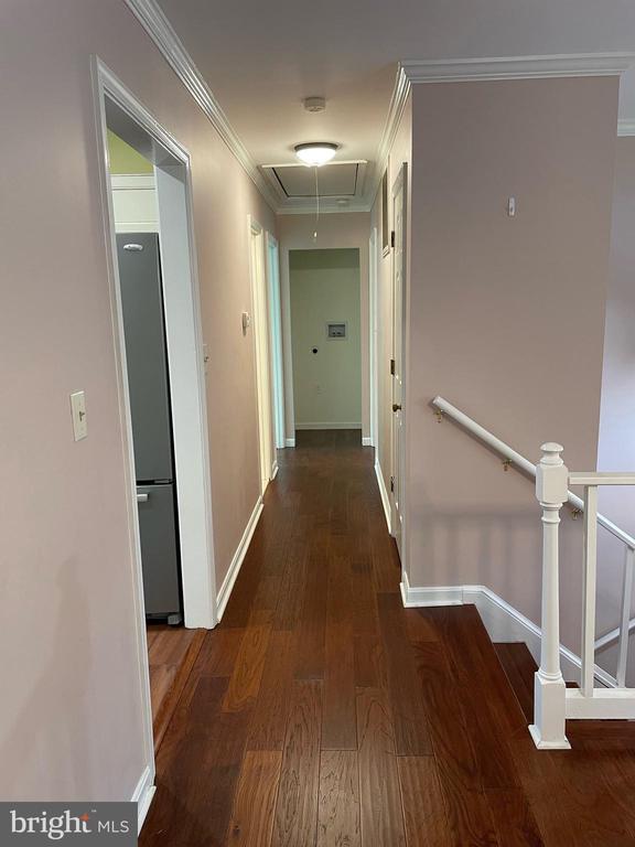 4504 Mine Rd, Fredericksburg, VA 22408 - hallway with attic access, wood finished floors, baseboards, an upstairs landing, and crown molding
