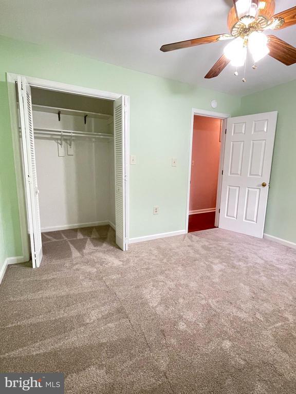 4504 Mine Rd, Fredericksburg, VA 22408 - unfurnished bedroom with carpet floors, a closet, baseboards, and ceiling fan