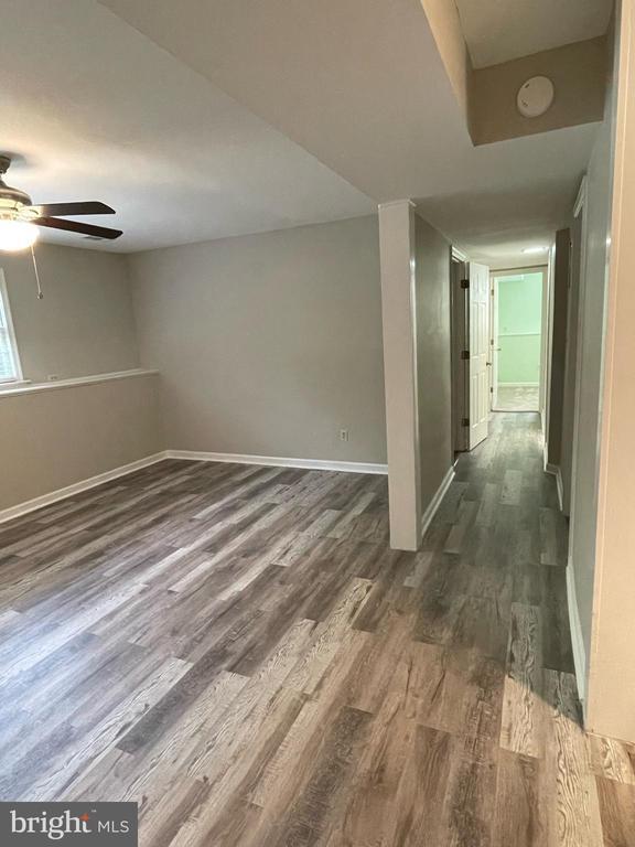 4504 Mine Rd, Fredericksburg, VA 22408 - basement featuring dark wood-style floors, baseboards, and a ceiling fan