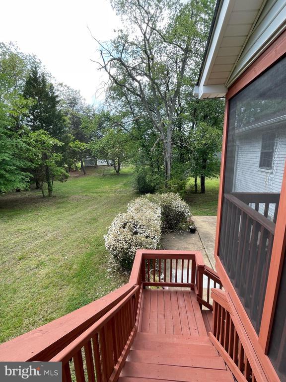 4504 Mine Rd, Fredericksburg, VA 22408 - wooden deck featuring a lawn and view of scattered trees