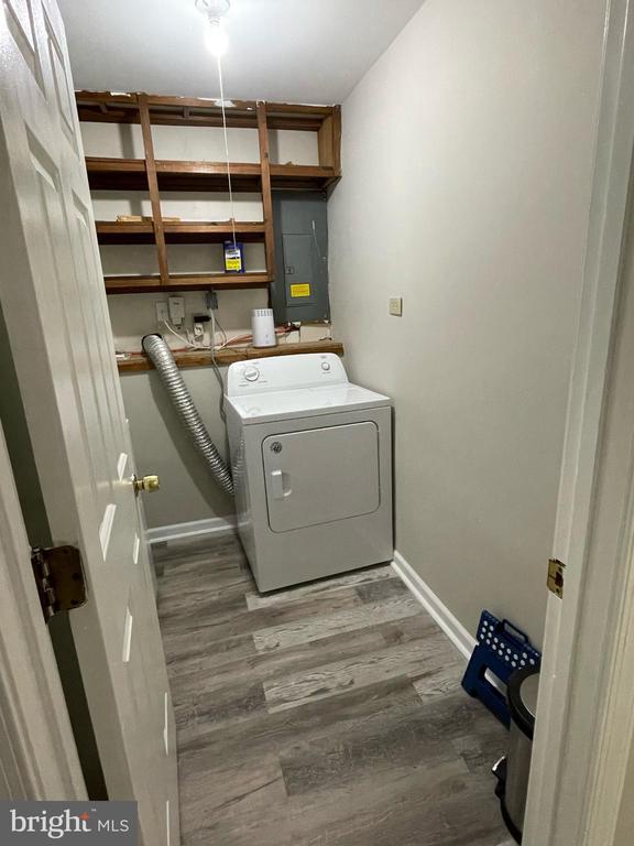 4504 Mine Rd, Fredericksburg, VA 22408 - laundry area featuring washer / dryer, electric panel, wood finished floors, and baseboards