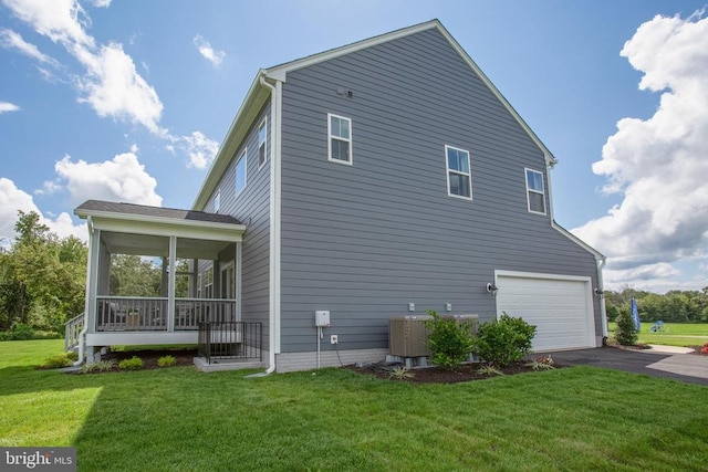 18 Whitehall Blvd, Spotsylvania, VA 22551 - view of home's exterior featuring asphalt driveway, cooling unit, an attached garage, a sunroom, and a lawn
