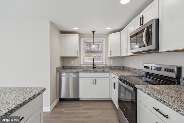 2215 Hoover Rd W, Haywood, VA 22722 - kitchen with stainless steel appliances, a sink, light wood-style flooring, white cabinetry, and recessed lighting